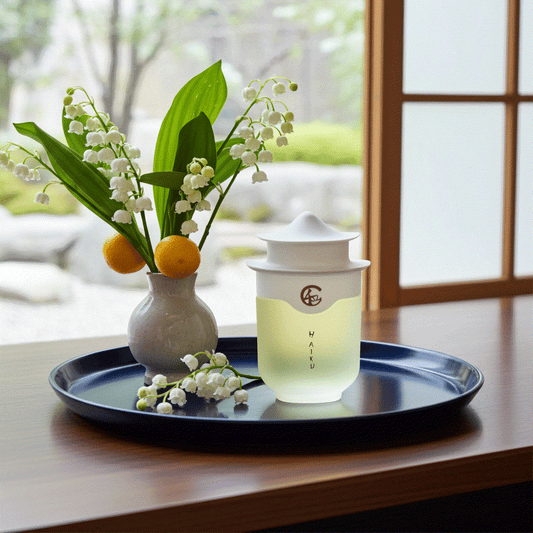 Avon Haiku Original Eau De Perfume bottle with floral vase on tray in serene indoor setting