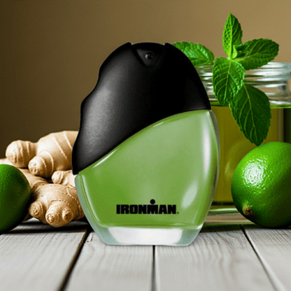 Ironman Eau De Toilette men's cologne spray bottle with ginger, lime, and mint ingredients on wooden surface