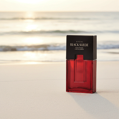 Avon Black Suede men’s eau de toilette bottle on sandy beach with ocean background