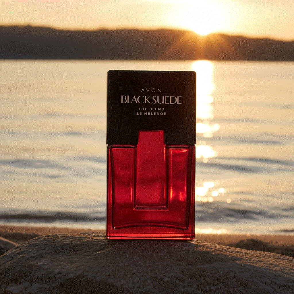 Avon Black Suede men's eau de toilette bottle with sunset over water background