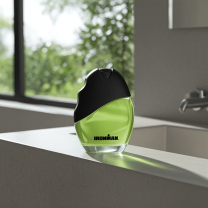 Ironman Eau De Toilette men’s cologne spray 2.5 fl oz with green liquid and black cap on white surface