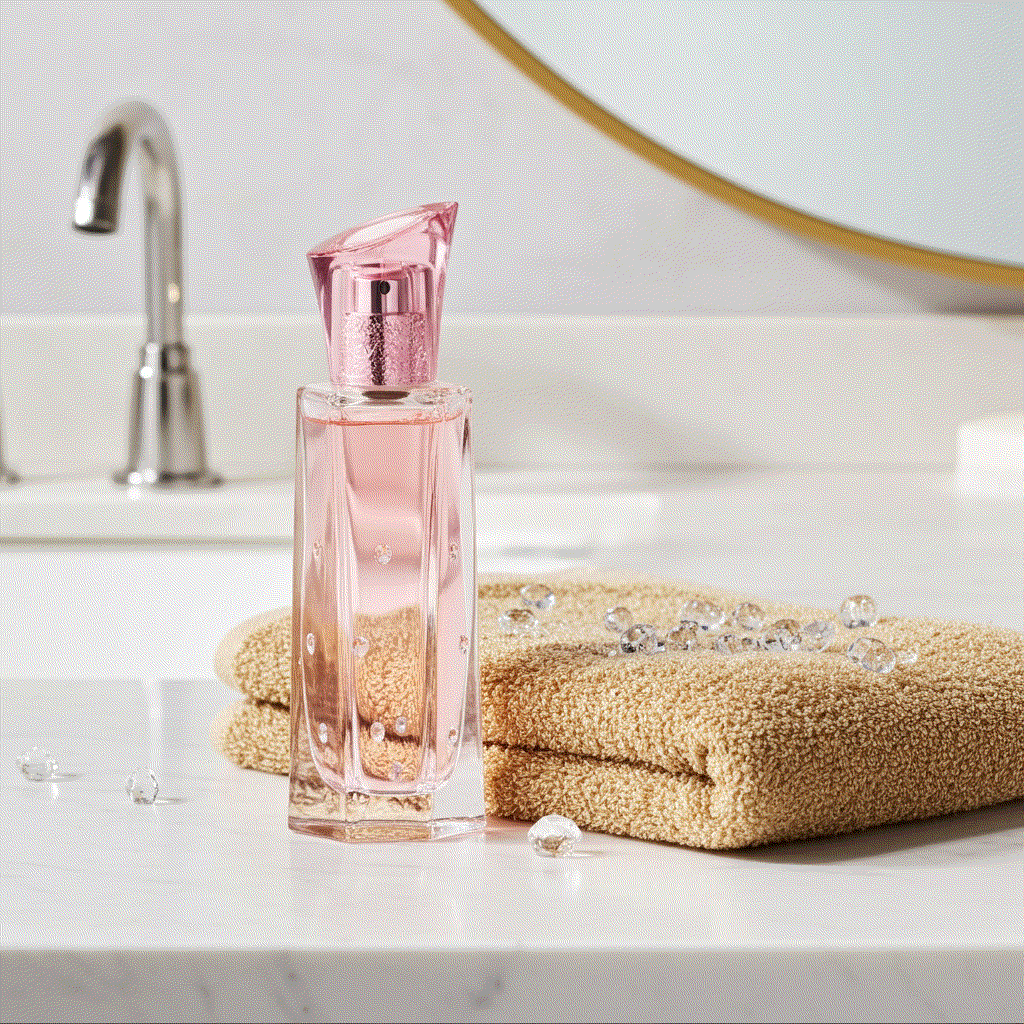 Dreamlife Bouquet Eau De Perfume pink floral bottle on bathroom counter with towel and crystals